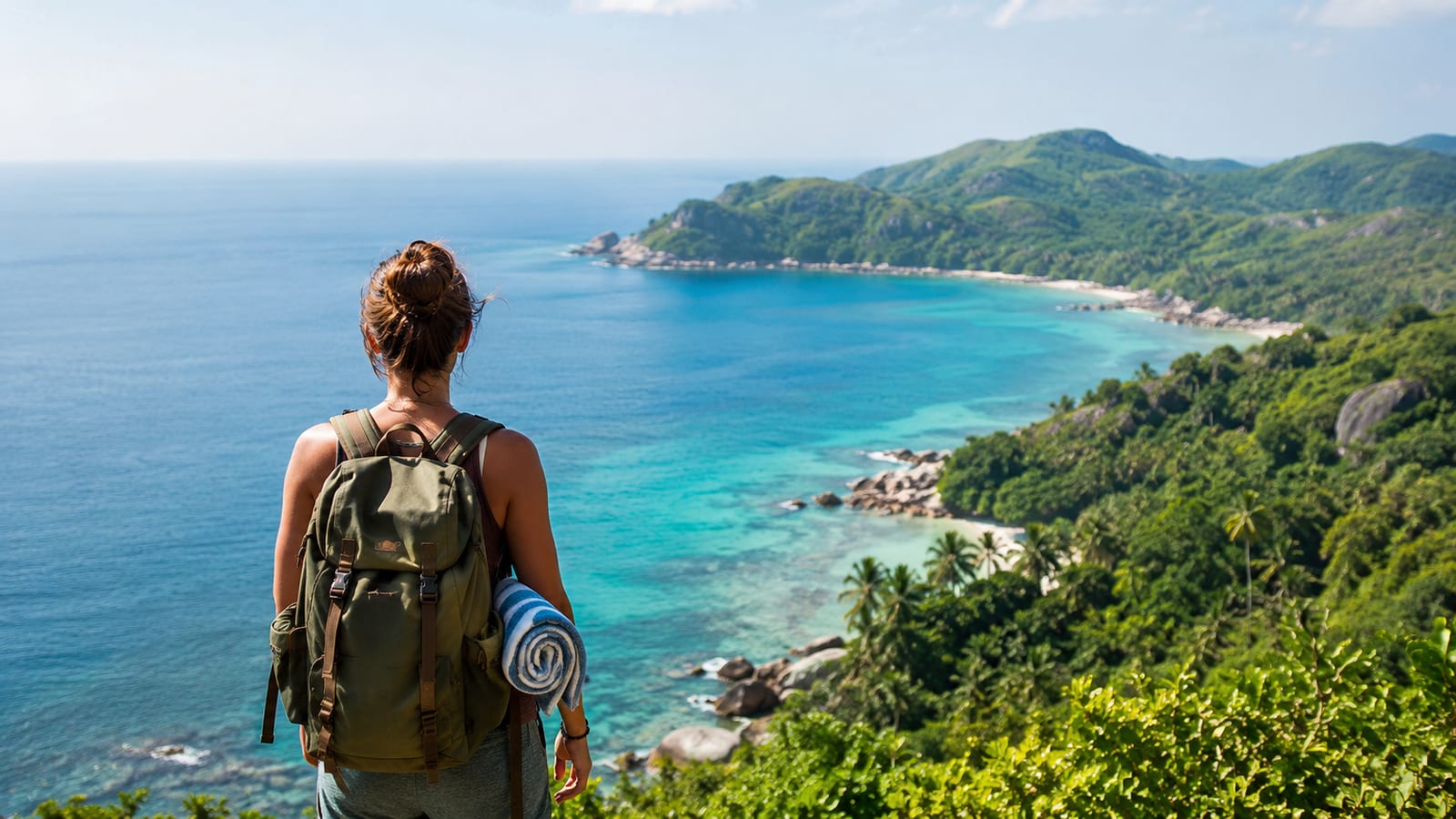 Solo traveler with daypack and swim gear overlooking a quiet tropical coastline