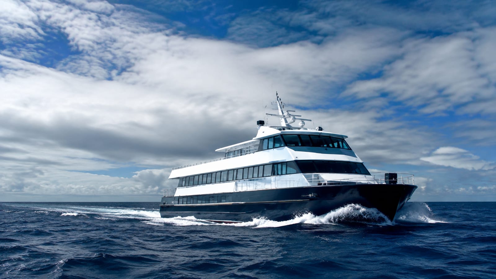 Passenger ferry navigating rough open water under dark windswept clouds